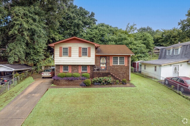 Large yards frame this split-level home on a quiet Lipscomb street.