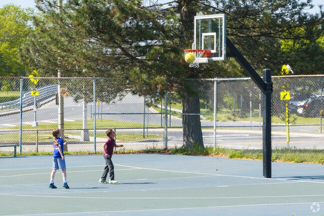 Two kids showing their skills on the court in Rosemont Park.