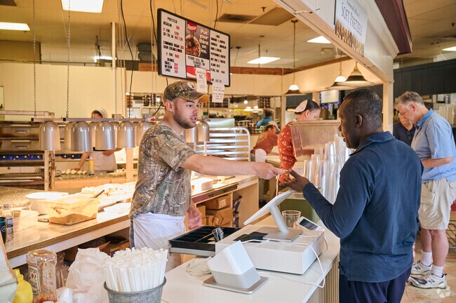 A customer purchases fresh made pretzels inside the Lancaster Dutch Market in Germantown.