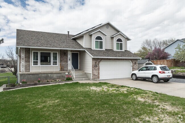 Brick homes with oversized garages line this quiet street in Uintah.