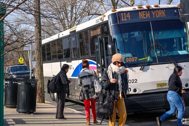 Commuters board and alight the express bus to New York City in Springfield, NJ.