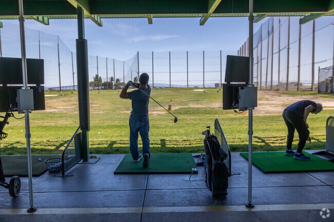 Practice your swing at Mariners Point Golf Center's driving range in Foster City.