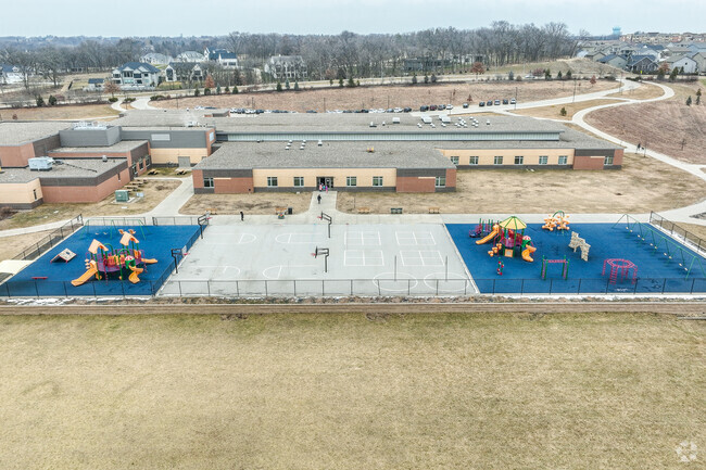 Playgrounds, outdoor games, and ample green space await students at recess.