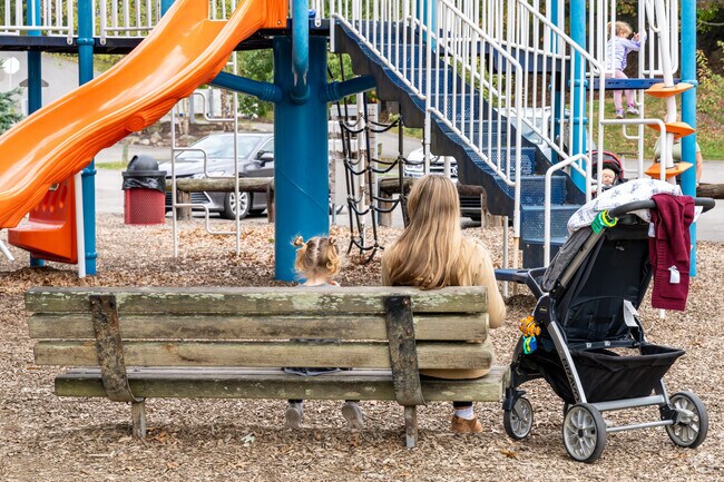 A Shaler Township mother takes a break with her children at Kiwanis Park.