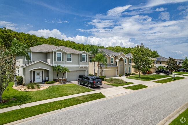 A row of two story single family homes with attached garages in Water Edge community.
