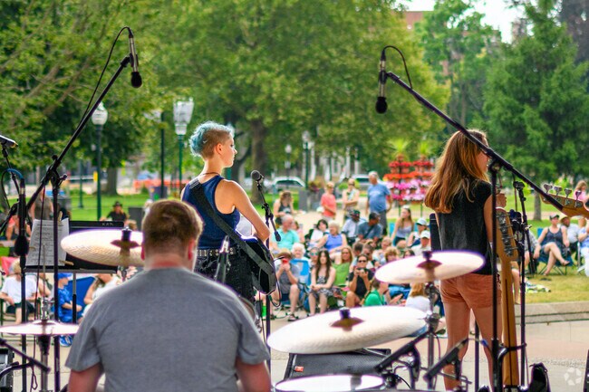 Musicians from the Academy of Rock play at Bronson Park in the Central Business District.