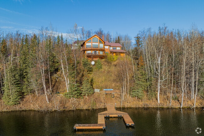 A mountain home features a dock in South Lakes, Wasilla.