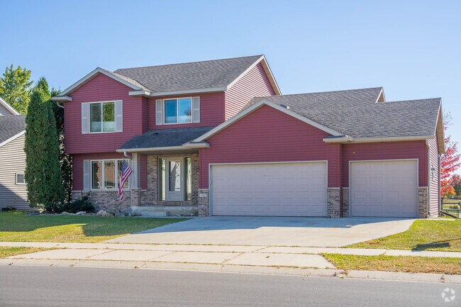 A red house with a 3 car garage in the Wedgewood Hills neighborhood.