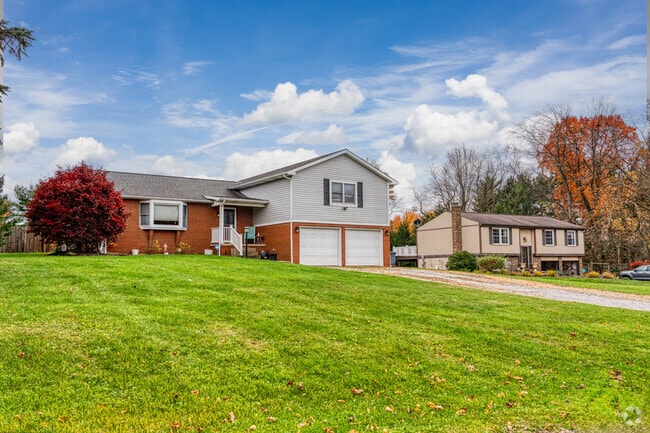 A bi-level home sits next to a split-level home in Raccoon Township.