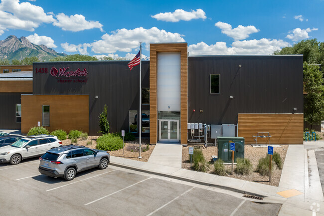 The entrance of Wasatch is stunning with its design incorporating wood tones and gray and red.