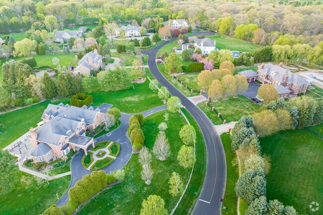 Winding roads snake between the new development of mansions in Muttontown.