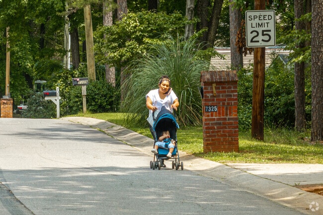 Idlewild South residents take advantage of the shade from the many large trees.