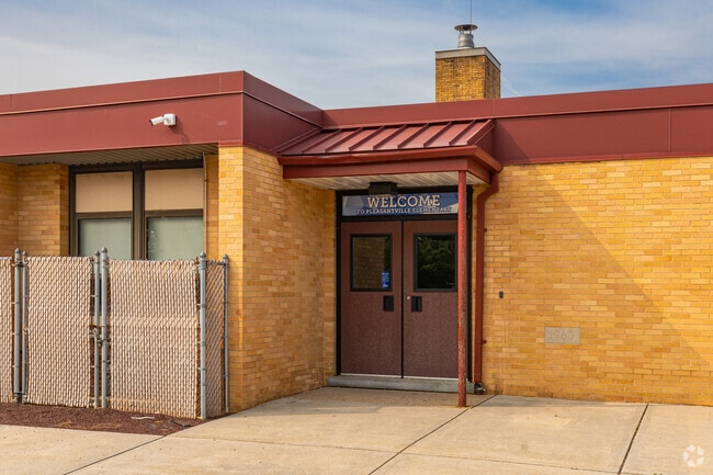 An alternate entrance to Pleasantville Elementary lets out students right to the recess area.