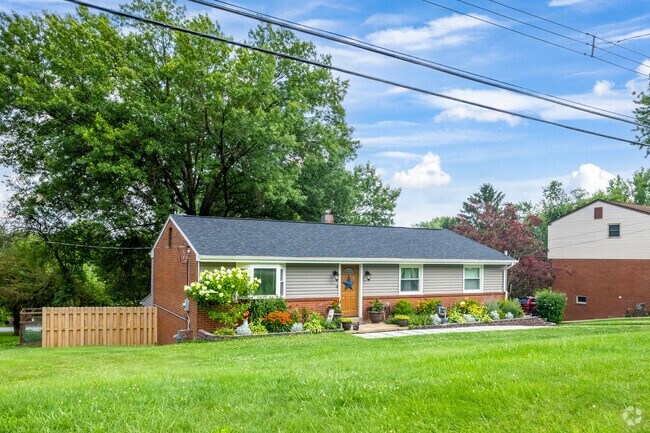 This ranch style home in Moon Township has lovely landscaping and a trimmed lawn.