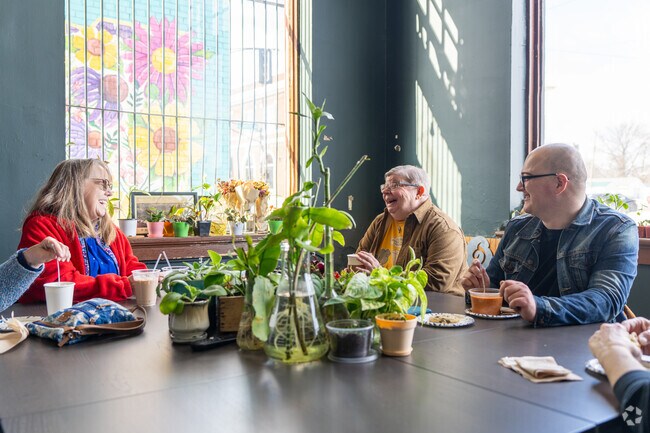 Friends gather in the meeting rooms at 12 Points Market in The Avenues.
