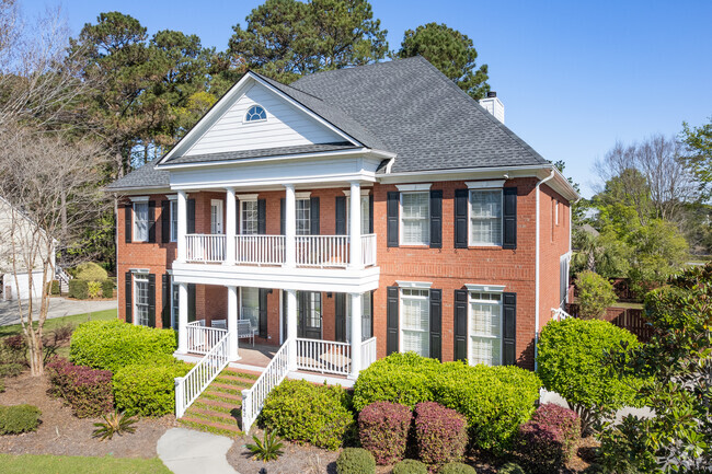 This beautiful Dunes West Colonial home has stunning landscape.