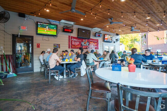 Grab a table with your friends on the patio at Alpha Tavern in Woodsdale.