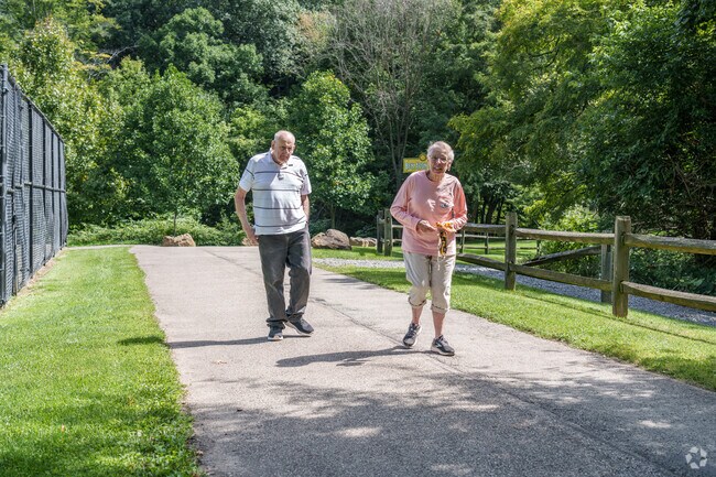 An older couple enjoys some exercise along a path at Avon Park in Ben Avon Heights.