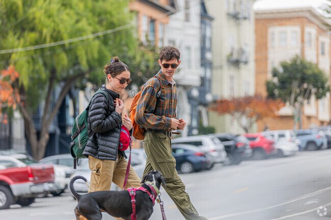 Couple walking their dog, embracing Anza Vista's friendly vibe.