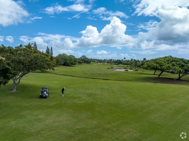 A magical sky blankets this lone golfer in the open spaces of the Koolina Golf Course.