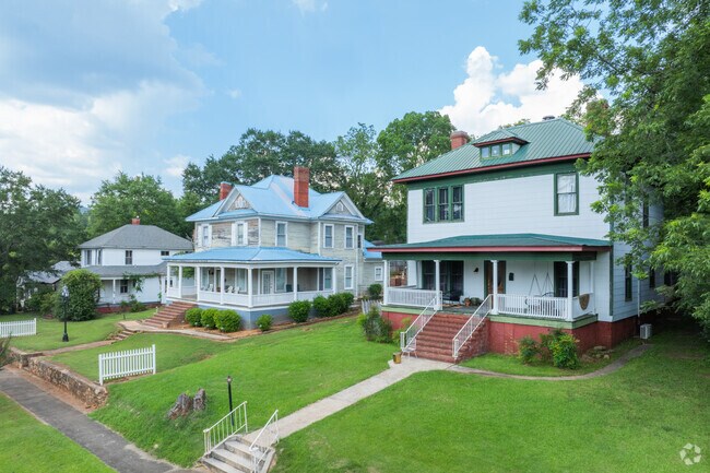 Brightly painted wood-paneled homes in Anniston offer spacious porches.