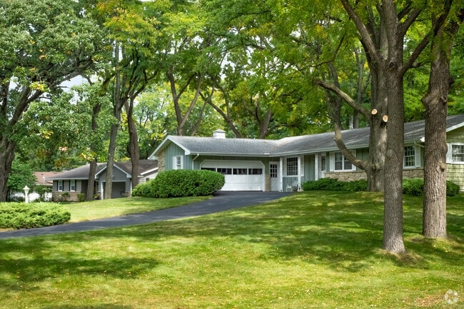 Mature landscaping is a common feature of Arbor Hills lawns.