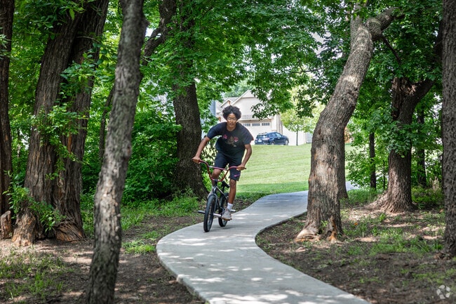Residents in Falcon Falls can enjoy a bike ride through tree-covered trails.