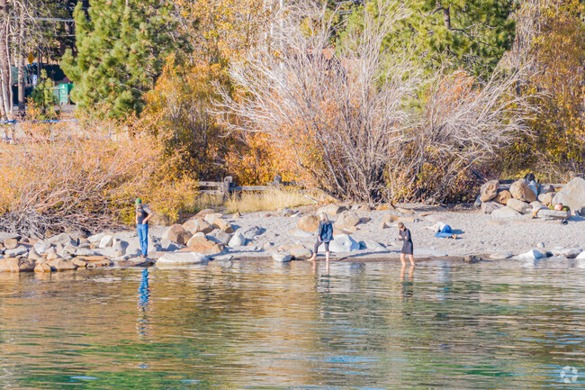 Friends enjoy the clear waters and rocky shores of Lake Tahoe in Tahoe Vista.