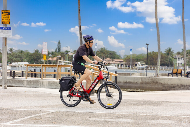 A resident leisurely cycling through the serene streets of Ocean Breeze.