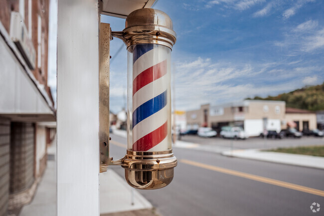 The traditional barber pole greets guests at Darnley’s Barber Shop in McDonald.