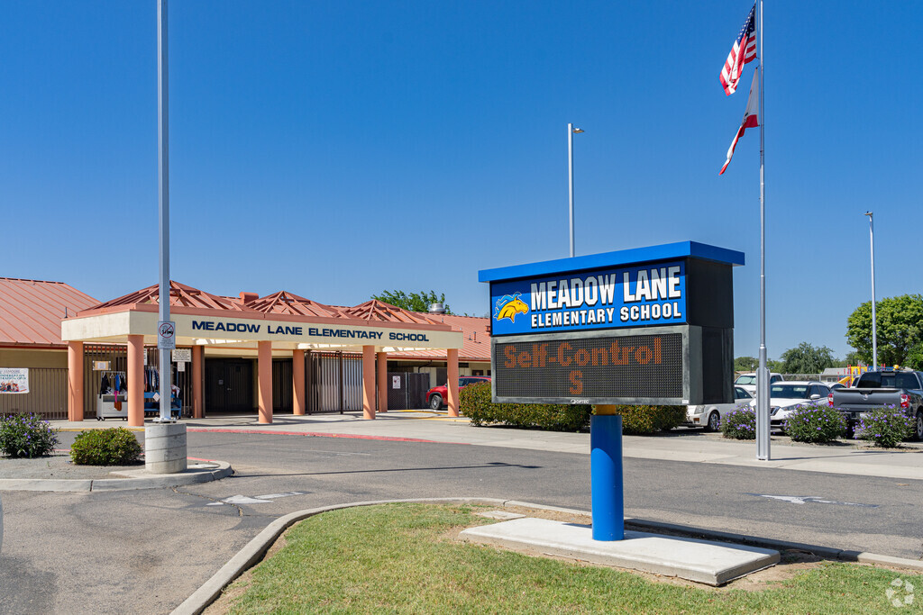 A large lighted marquee at the entrance to Meadow Lane Elementary School displays events.