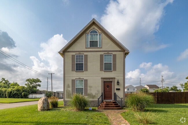 A charming wooden door adorns this single family home in Devon Triangle.