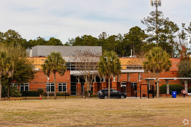 The Haut Gap Middle School entrance is lined with palm trees.