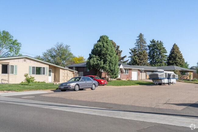 A row of classic ranch homes lines the quiet streets of Rolling Hills, blending timeless design with laid-back suburban charm.
