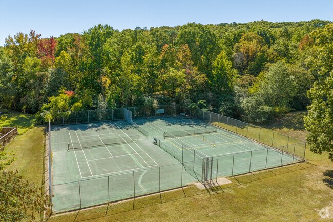 Hillsborough residents grab their racquet and play some tennis at Carriage Creek Park.