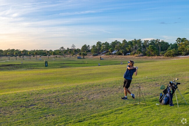 A kid taking a shot at US 1 golf range.