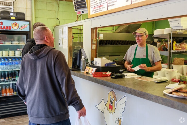 A group of men orders famous chicken at Sam's Chicken Land in Westvale, NY.