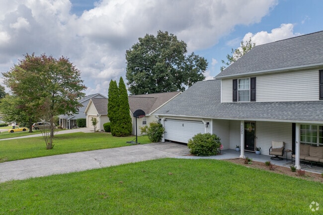 Well-kept lawns and leafy trees surround traditional-style homes in Amherst’s suburbs.