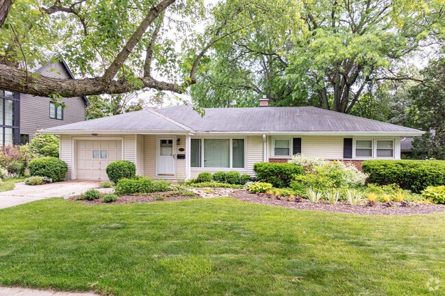 A Ranch home in Naperville's East Highland community sits before a beautiful, mature tree.