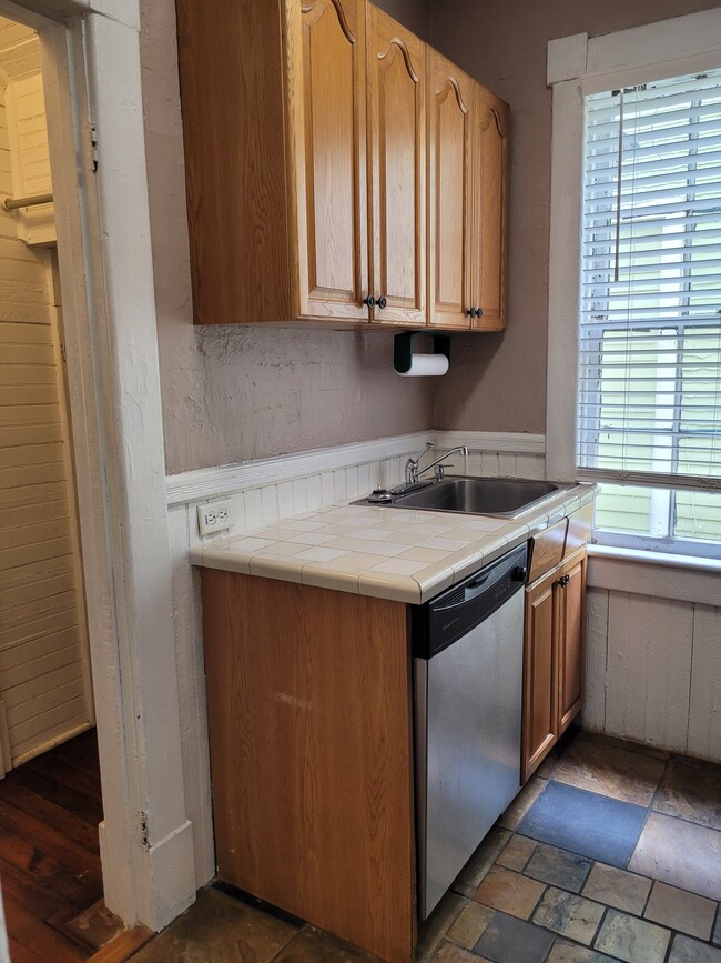 Kitchen-All Electric Appliances: Dishwasher. Window overlooks patio. Slate floor.