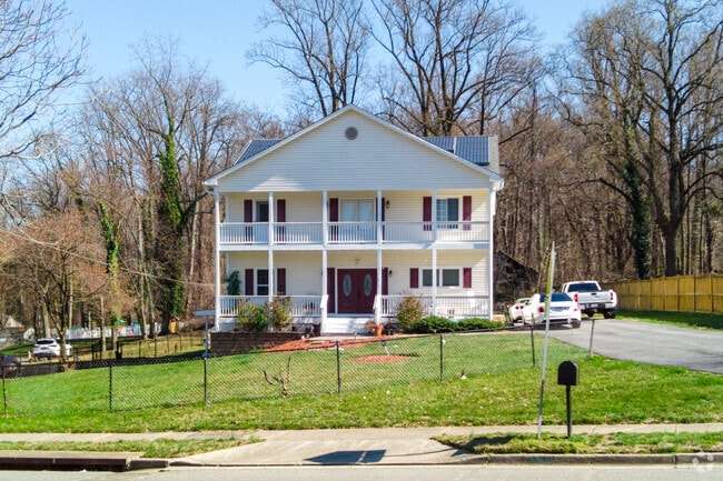 A large Federal-style home stands proudly among the elegant residences of Coral Hills.