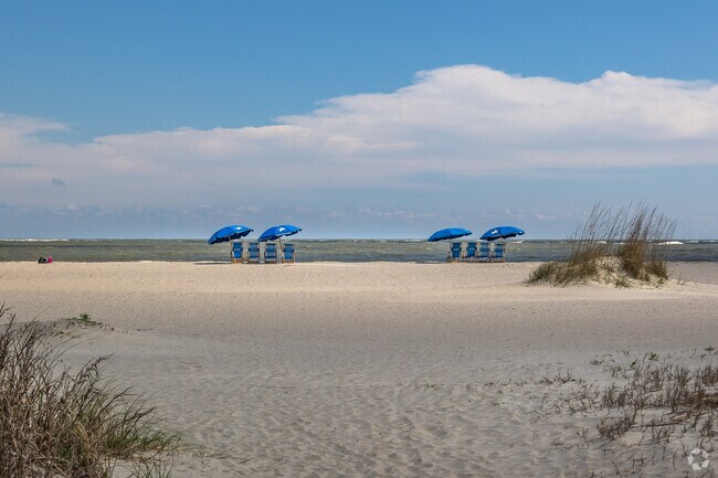 Relax by the water with shaded umbrellas and chairs on the beach at Isle of Palms.