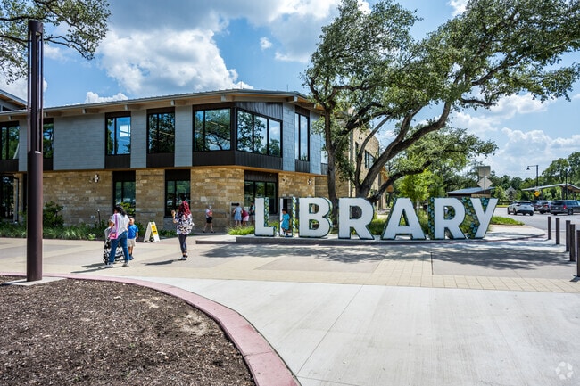 Cedar Park Public Library has a huge letter sign in front making it an inviting place to check out books in Cedar Park Ranchettes.