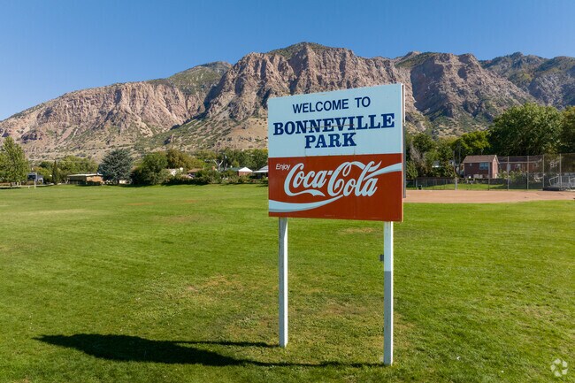 A vintage style Coca Cola sign on a large lawn welcomes people to Bonneville Park.