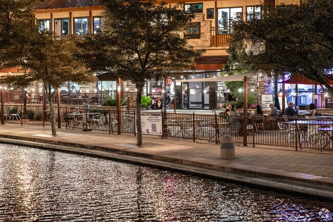 Take advantage of the outdoor patio space along Riverwalk at night in Downtown.