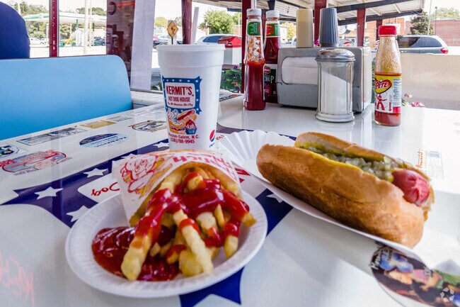 Customers can eat hot dogs and fries at Kermit's Hot Dog House near Forest Park.