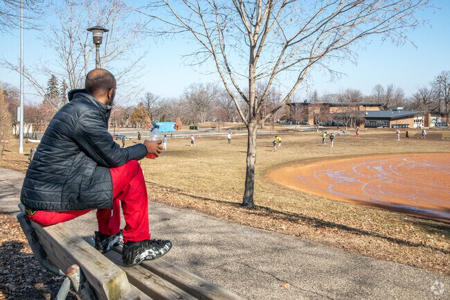 A local resident watching a pick-up soccer game in Folwell Park.