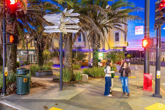 A group of friends waits for the light to change under this odd street sign in Lone Mountain.