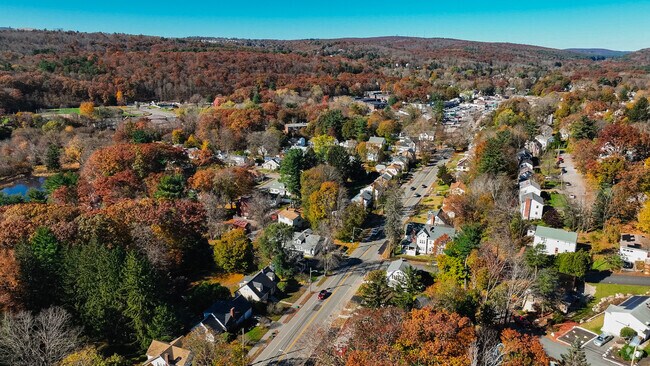 The beautiful streets of Tatnuck has many colorful fall trees.