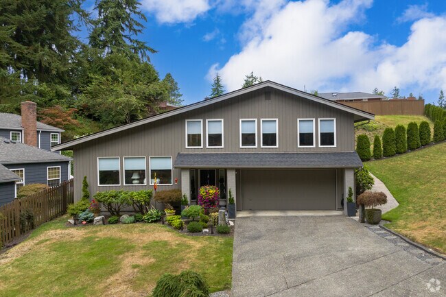 A modern home overlooks wooded slopes in Everett’s South Forest Park.